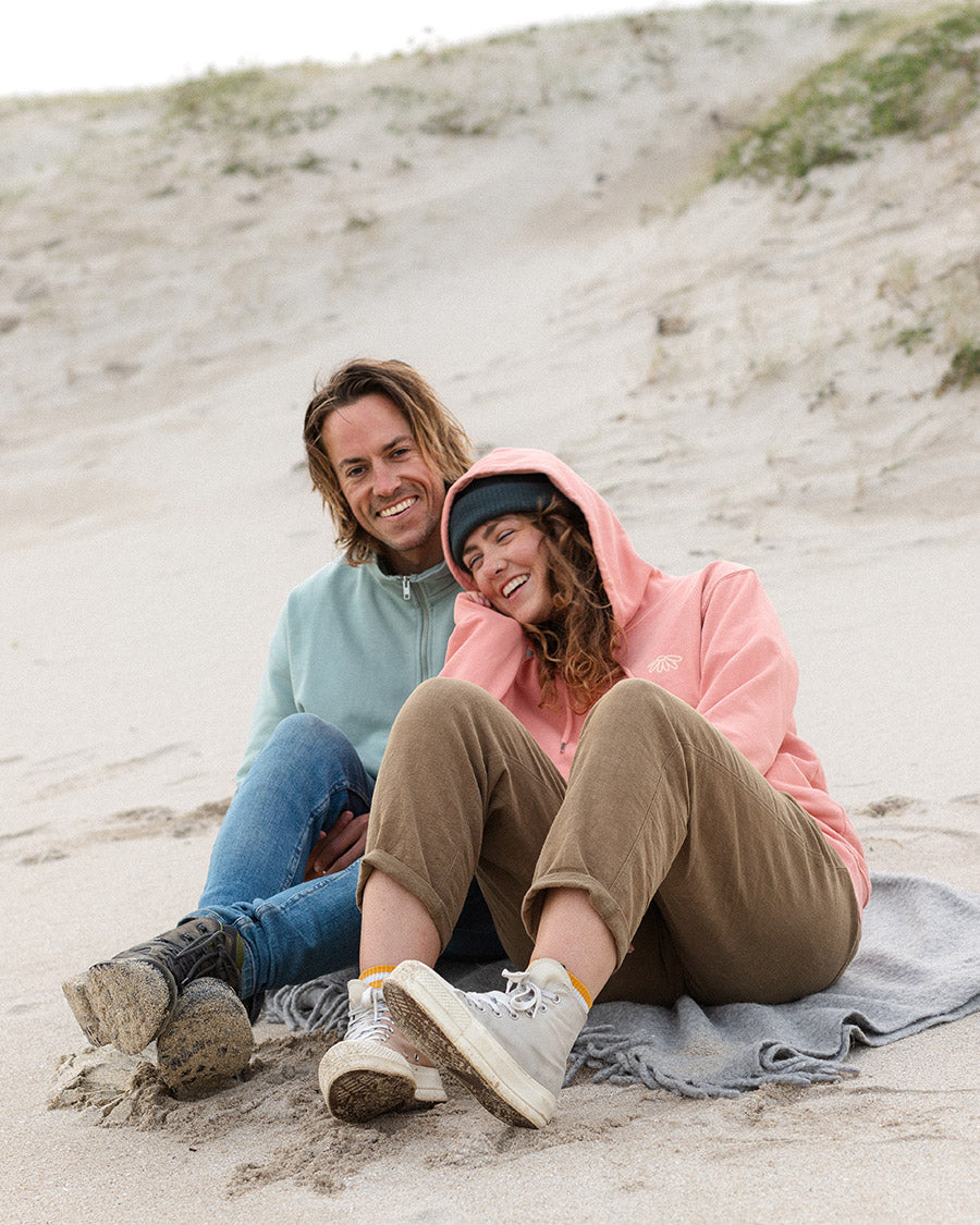 Man and Women on beach wearing Organic Clothing